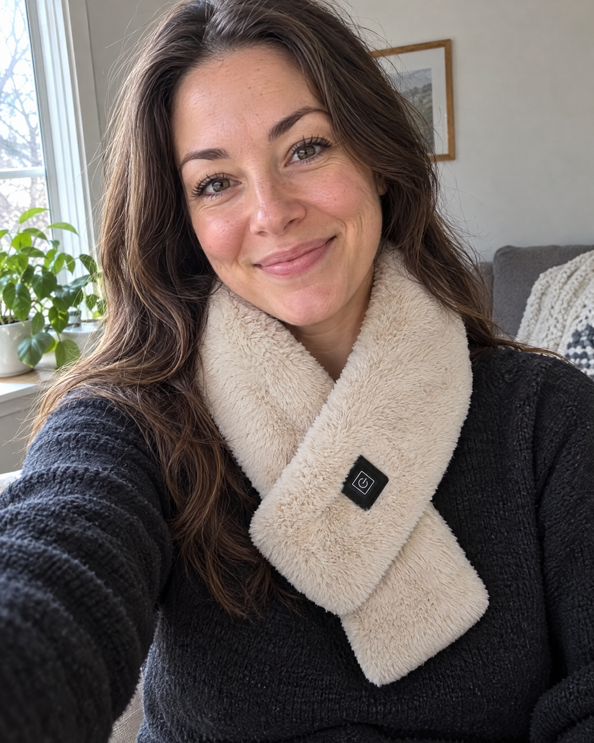 Woman smiling in a selfie wearing the camel Cinderly USB heated scarf
